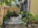 Secluded backyard with potted plants and a small seating area at 1409 Oak Pl # F, Apopka, FL 32712