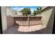 A wood balcony with railings, showing the outdoor space for this townhome at 1409 Oak Pl # F, Apopka, FL 32712
