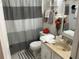 Cozy bathroom featuring a patterned shower curtain, towels, vanity with sink, and a stylish design at 1409 Oak Pl # F, Apopka, FL 32712