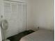 Cozy bedroom with closet, bed, and fan at 1409 Oak Pl # F, Apopka, FL 32712