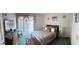 Cozy bedroom with a comfortable bed, neutral walls, and natural light from a window at 1409 Oak Pl # F, Apopka, FL 32712