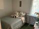 Small bedroom with a bed, side table, and window, ideal for a guest or  at 1409 Oak Pl # F, Apopka, FL 32712