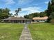 Community clubhouse and amenities surrounded by green lawns and trees on a sunny day at 1409 Oak Pl # F, Apopka, FL 32712