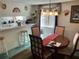 Dining area with a round table set for four, illuminated by a stylish chandelier at 1409 Oak Pl # F, Apopka, FL 32712