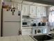 Bright kitchen featuring white appliances, countertops, and ample storage space with an overhead vent at 1409 Oak Pl # F, Apopka, FL 32712