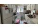 Bright kitchen featuring white appliances and ample counter space with views of the backyard at 1409 Oak Pl # F, Apopka, FL 32712