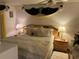 Comfortable main bedroom with mirrored headboard, side tables, lamps, and decorative accents at 1409 Oak Pl # F, Apopka, FL 32712