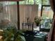 Bright sun room with large windows, vertical blinds, and lush plants, providing a serene space at 1409 Oak Pl # F, Apopka, FL 32712