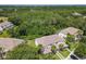 Aerial view of townhomes surrounded by lush greenery and mature trees at 1521 Tranquil Ave, Clermont, FL 34714