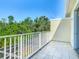 Enjoy the view from this balcony overlooking lush greenery and blue skies at 1521 Tranquil Ave, Clermont, FL 34714