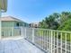 Bright balcony view overlooking tropical landscaping and nearby homes at 1521 Tranquil Ave, Clermont, FL 34714