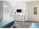 Bedroom with modern dresser, mounted TV, and window seat at 1521 Tranquil Ave, Clermont, FL 34714