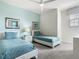 Twin bedroom featuring two beds, soft blue color scheme, and a window at 1521 Tranquil Ave, Clermont, FL 34714