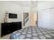 Bedroom with modern dresser, mounted TV, and ensuite bathroom at 1521 Tranquil Ave, Clermont, FL 34714