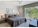 Comfortable bedroom featuring balcony access with bright, natural light and a ceiling fan at 1521 Tranquil Ave, Clermont, FL 34714