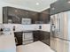 Beautiful kitchen with stainless steel appliances and modern, dark cabinetry at 1521 Tranquil Ave, Clermont, FL 34714