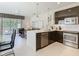 Modern kitchen with stainless steel appliances and an adjacent living area at 1521 Tranquil Ave, Clermont, FL 34714