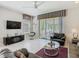 Comfortable living room featuring modern furniture and access to an outdoor patio at 1521 Tranquil Ave, Clermont, FL 34714