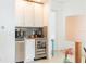 Modern bar area with white cabinets, stainless steel appliances, and a sleek design at 1545 Fairview Cir, Reunion, FL 34747