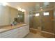 Modern bathroom with double shower heads and granite countertops at 1545 Fairview Cir, Reunion, FL 34747