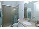Tiled bathroom with glass shower door and granite vanity countertop at 1545 Fairview Cir, Reunion, FL 34747