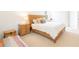 Bright bedroom with a wooden bed frame, carpeted floors, and neutral décor at 1545 Fairview Cir, Reunion, FL 34747