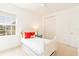 Bright bedroom with white walls, matching bedframe and window with outdoor view at 1545 Fairview Cir, Reunion, FL 34747
