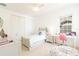 Bedroom featuring a single bed, white walls, white furnishings, and a window with natural light at 1545 Fairview Cir, Reunion, FL 34747