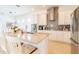 Open kitchen with stainless steel appliances, white cabinets, and a large island with bar seating at 1545 Fairview Cir, Reunion, FL 34747