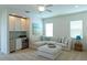 Cozy living room features built-in wet bar and comfortable seating at 1545 Fairview Cir, Reunion, FL 34747