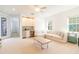Spacious living room featuring a wet bar, carpeted floors, and plenty of natural light at 1545 Fairview Cir, Reunion, FL 34747