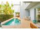 Backyard pool with patio, landscaping, and covered outdoor seating area at 1545 Fairview Cir, Reunion, FL 34747