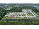 Aerial view showcasing a neighborhood, with homes backing onto a tranquil lake at 1774 Pasture Loop, Oviedo, FL 32765