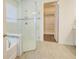 Bright bathroom featuring a glass-enclosed shower and a view into a walk-in closet at 1774 Pasture Loop, Oviedo, FL 32765