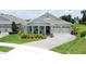 Inviting home with a well-maintained lawn, stylish landscaping, and a brick-paved driveway leading to a two-car garage at 1774 Pasture Loop, Oviedo, FL 32765
