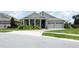 Attractive home featuring a well-kept lawn, a brick-paved driveway, and a charming front porch with stately columns at 1774 Pasture Loop, Oviedo, FL 32765