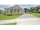 Beautiful home with lush landscaping, a brick driveway, and a cozy front porch, perfect for enjoying the outdoors at 1774 Pasture Loop, Oviedo, FL 32765
