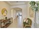 Elegant foyer with hardwood floors, stylish furnishings, and an inviting ambiance leading into the home's living spaces at 1774 Pasture Loop, Oviedo, FL 32765