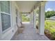 Welcoming front porch featuring classic brick pavers, stylish columns, and comfortable seating to enjoy the outdoors at 1774 Pasture Loop, Oviedo, FL 32765