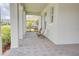 Inviting front porch with classic brick pavers and comfortable seating, perfect for relaxing and enjoying the neighborhood views at 1774 Pasture Loop, Oviedo, FL 32765