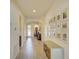 Bright hallway with decorative pictures, display cabinet, and front door with wreath at 1774 Pasture Loop, Oviedo, FL 32765