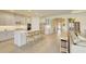 Well-lit kitchen featuring a large island with seating and views of the living room at 1774 Pasture Loop, Oviedo, FL 32765