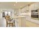 Open kitchen features large island with seating, stainless steel appliances, and white cabinets at 1774 Pasture Loop, Oviedo, FL 32765