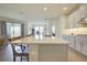 Kitchen features a large central island with seating and open plan to living room at 1774 Pasture Loop, Oviedo, FL 32765
