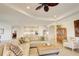 Bright living room featuring a sectional sofa, woven ottoman, and views of the kitchen at 1774 Pasture Loop, Oviedo, FL 32765