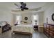 The main bedroom has a decorative wreath above the bed, and lots of natural light at 1774 Pasture Loop, Oviedo, FL 32765