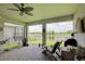 Covered patio area with brick flooring, ceiling fan, and picturesque lake views at 1774 Pasture Loop, Oviedo, FL 32765