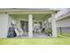 Relaxing covered patio with a ceiling fan and views of the backyard and scenic pond at 1774 Pasture Loop, Oviedo, FL 32765