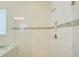 Brightly tiled glass-enclosed shower with mosaic tile accent strip at 1774 Pasture Loop, Oviedo, FL 32765