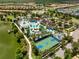 Aerial view of the community with multiple amenities, including a pool, lazy river, and sports courts at 1909 Majorca Dr, Kissimmee, FL 34747